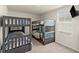 Bedroom featuring two sets of gray bunkbeds and a window at 3075 Meleto Blvd, New Smyrna Beach, FL 32168