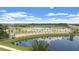 Venetian Bay entrance sign reflected in a pond, surrounded by palm trees, golf course and blue sky at 3075 Meleto Blvd, New Smyrna Beach, FL 32168