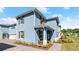 Beautiful exterior of a two-story home with a blue facade, brown shutters, and professionally landscaped yard at 3075 Meleto Blvd, New Smyrna Beach, FL 32168