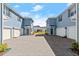 Street view of blue townhomes with white garages and lush landscaping at 3075 Meleto Blvd, New Smyrna Beach, FL 32168