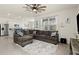Spacious living room with a comfortable sectional sofa, ceiling fan, tile floors, and plenty of natural light at 3075 Meleto Blvd, New Smyrna Beach, FL 32168