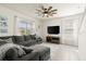 Comfortable living room with a large sectional sofa, ceiling fan, bright windows, and a mounted television at 3075 Meleto Blvd, New Smyrna Beach, FL 32168