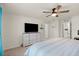Calm main bedroom with a ceiling fan, neutral walls, a comfortable bed, and a TV on a dresser at 3075 Meleto Blvd, New Smyrna Beach, FL 32168