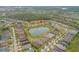 Expansive aerial view of a community showcasing a serene pond, mature trees, and well-maintained residential areas at 3145 Connemara Dr, Ormond Beach, FL 32174