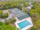 Aerial view of community amenities including a sparkling pool, tennis courts, and a clubhouse surrounded by lush greenery at 3145 Connemara Dr, Ormond Beach, FL 32174
