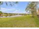 Lush backyard with a picturesque pond and fountain, surrounded by well-manicured lawns and trees at 3145 Connemara Dr, Ormond Beach, FL 32174