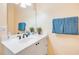 Bathroom featuring tiled floors, vanity with a vessel sink, framed mirror, and decor at 3145 Connemara Dr, Ormond Beach, FL 32174