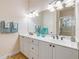 Well-lit bathroom with a double sink vanity and shower at 3145 Connemara Dr, Ormond Beach, FL 32174