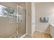 Bathroom featuring a clear glass enclosed shower, door and towel rack at 3145 Connemara Dr, Ormond Beach, FL 32174