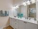 Bathroom featuring double vanity with dual sinks and decorative bottles and towels at 3145 Connemara Dr, Ormond Beach, FL 32174