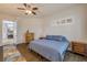 Bedroom featuring wood floors, ceiling fan, and an adjacent room at 3145 Connemara Dr, Ormond Beach, FL 32174