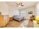 Comfortable bedroom with wood-look floors, shuttered windows, and a ceiling fan at 3145 Connemara Dr, Ormond Beach, FL 32174