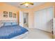 Bright bedroom with closet, featuring a bed, neutral carpet, and soft, neutral paint at 3145 Connemara Dr, Ormond Beach, FL 32174