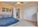 Upstairs bedroom featuring blue bedding and an open doorway at 3145 Connemara Dr, Ormond Beach, FL 32174