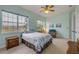 Bright bedroom featuring two large windows, ceiling fan and recliner at 3145 Connemara Dr, Ormond Beach, FL 32174