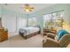 Tranquil bedroom featuring neutral carpet, natural light, a ceiling fan, and furniture at 3145 Connemara Dr, Ormond Beach, FL 32174
