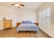 Inviting bedroom with wood-look floors, shuttered windows, and a ceiling fan at 3145 Connemara Dr, Ormond Beach, FL 32174