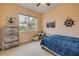 bedroom with carpet, muted orange walls and marine themed decor at 3145 Connemara Dr, Ormond Beach, FL 32174
