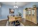 Dining room boasts a modern chandelier, stylish wood flooring, and tasteful decor at 3145 Connemara Dr, Ormond Beach, FL 32174