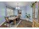 Dining room boasts a modern chandelier, stylish wood flooring, and tasteful decor at 3145 Connemara Dr, Ormond Beach, FL 32174