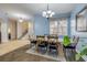 Bright dining room with hardwood floors and an entrance to stairs and tile hallway at 3145 Connemara Dr, Ormond Beach, FL 32174