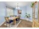 Formal dining room with hardwood floors, classic chandelier, and a large window with white shutters at 3145 Connemara Dr, Ormond Beach, FL 32174