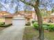Home featuring a Spanish tile roof, landscaped yard, and an attached two-car garage at 3145 Connemara Dr, Ormond Beach, FL 32174