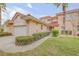 Charming home featuring a Spanish tile roof, landscaped yard, and an attached two-car garage at 3145 Connemara Dr, Ormond Beach, FL 32174
