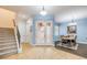 Bright foyer with tile flooring leading to a dining area with wood floors and a staircase at 3145 Connemara Dr, Ormond Beach, FL 32174