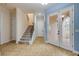 Foyer features staircase, tile flooring, and decorative glass doors at 3145 Connemara Dr, Ormond Beach, FL 32174
