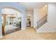Spacious entryway with ceramic tile flooring, staircase with iron railing, and arched doorways to the living areas at 3145 Connemara Dr, Ormond Beach, FL 32174