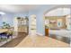 Open-concept home showcasing dining, kitchen, and living area with hardwood and tile flooring, arched doorways, and neutral paint at 3145 Connemara Dr, Ormond Beach, FL 32174