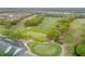 Aerial view of the lush, green golf course surrounded by mature trees and pristine landscaping, offering a serene setting at 3145 Connemara Dr, Ormond Beach, FL 32174