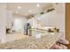 Charming kitchen featuring stainless appliances, granite countertops, and bright white cabinets with under cabinet lighting at 3145 Connemara Dr, Ormond Beach, FL 32174