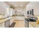 Open kitchen featuring granite counters, stainless appliances, and bright white cabinetry with under cabinet lighting at 3145 Connemara Dr, Ormond Beach, FL 32174