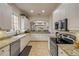 Open kitchen features white cabinets, granite countertops, and stainless steel appliances at 3145 Connemara Dr, Ormond Beach, FL 32174