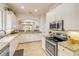 Open kitchen with granite counters, stainless appliances, breakfast bar open to living and dining area at 3145 Connemara Dr, Ormond Beach, FL 32174