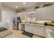 Bright kitchen with white cabinets, stainless steel appliances, and granite countertops at 3145 Connemara Dr, Ormond Beach, FL 32174