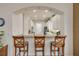 Bright kitchen features a granite breakfast bar with seating and white cabinets at 3145 Connemara Dr, Ormond Beach, FL 32174