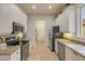 Well-lit kitchen features stainless steel appliances, granite countertops, and white cabinets at 3145 Connemara Dr, Ormond Beach, FL 32174