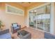 Inviting screened lanai with wicker furniture and tile flooring, leading to the home's interior at 3145 Connemara Dr, Ormond Beach, FL 32174