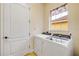Well lit laundry room featuring a modern washer and dryer and a window with valance at 3145 Connemara Dr, Ormond Beach, FL 32174