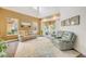 Bright living room with high ceilings, large windows, tan leather furniture, and sliding glass doors to the patio at 3145 Connemara Dr, Ormond Beach, FL 32174