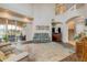 Open living room with high ceilings, a sofa, access to a covered patio and a staircase at 3145 Connemara Dr, Ormond Beach, FL 32174