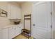 Mudroom with coat rack, bench, and white cabinets for storage at 3145 Connemara Dr, Ormond Beach, FL 32174