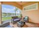 Inviting screened patio featuring wicker seating and a tranquil view of the pond at 3145 Connemara Dr, Ormond Beach, FL 32174
