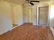 Spacious bedroom featuring a ceiling fan, wood floors, and closet at 318 S Massachusetts Ave, Deland, FL 32724