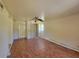 Bedroom featuring a ceiling fan, closet, and wood floors at 318 S Massachusetts Ave, Deland, FL 32724