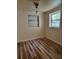 Bedroom with hardwood floors and two windows allowing for natural light at 318 S Massachusetts Ave, Deland, FL 32724