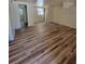 Bright living room featuring wood floors, a window, and neutral paint at 318 S Massachusetts Ave, Deland, FL 32724